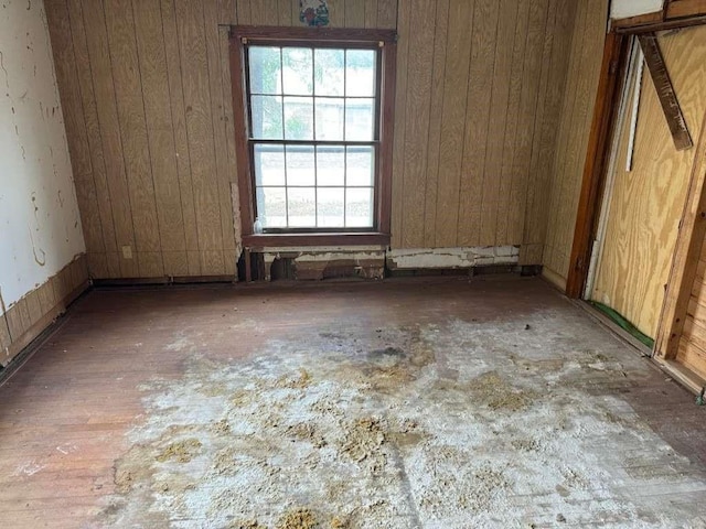 spare room with wooden walls