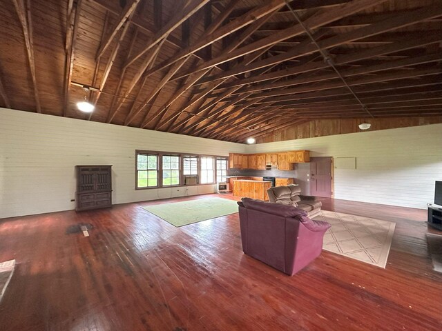 living room with high vaulted ceiling and dark wood finished floors