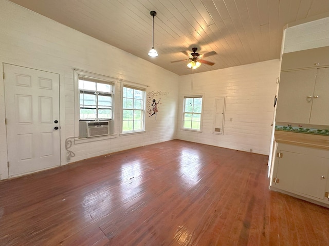 interior space featuring wood finished floors, a ceiling fan, cooling unit, and wooden ceiling