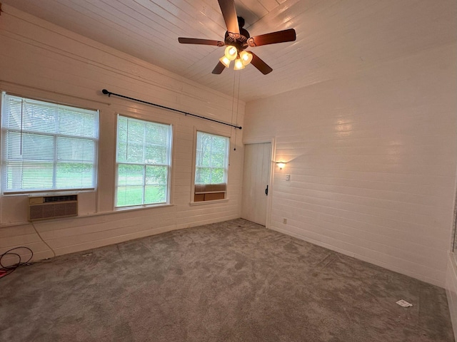 empty room with carpet flooring, a ceiling fan, and cooling unit