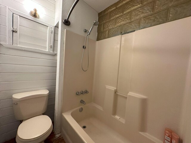 bathroom with shower / bathtub combination and toilet