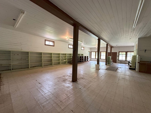 below grade area featuring tile patterned floors and wooden ceiling