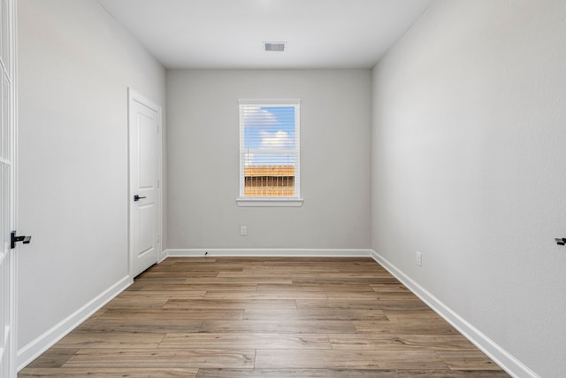 unfurnished room with baseboards, visible vents, and light wood-style flooring