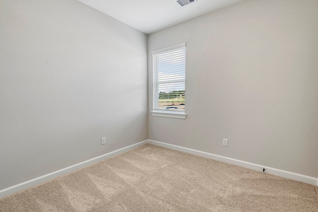 unfurnished room with light colored carpet, baseboards, and visible vents
