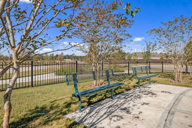 view of home's community featuring a yard and fence