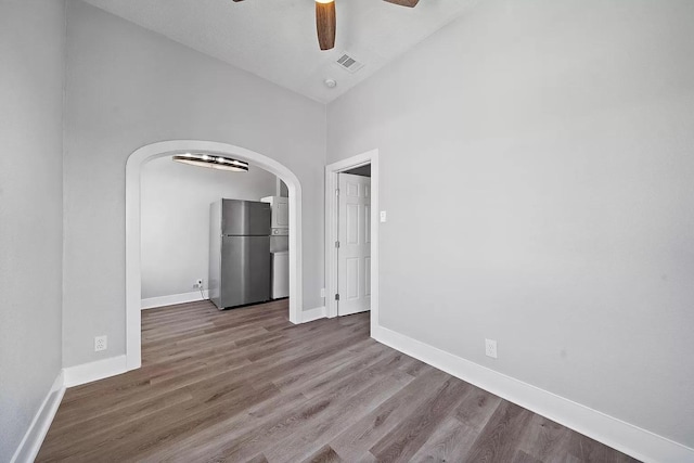 805 10th St, Galveston, TX 77550 - empty room featuring visible vents, a ceiling fan, wood finished floors, baseboards, and arched walkways