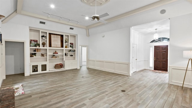unfurnished living room with light wood-type flooring, rail lighting, ceiling fan, and visible vents