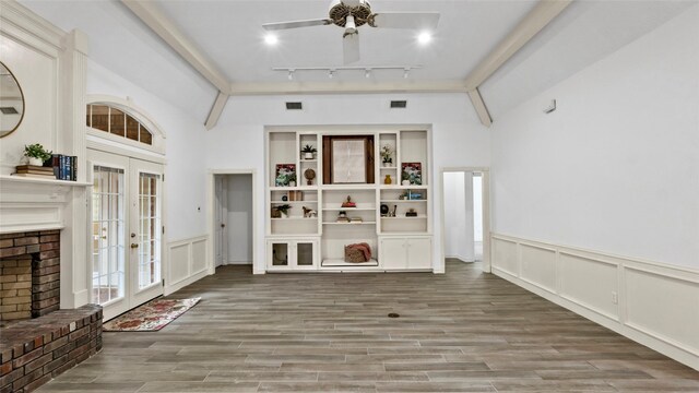 interior space with ceiling fan, track lighting, a decorative wall, french doors, and wood finished floors