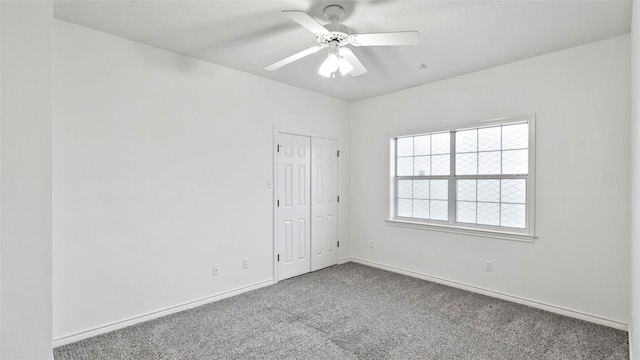empty room featuring baseboards, carpet flooring, and ceiling fan