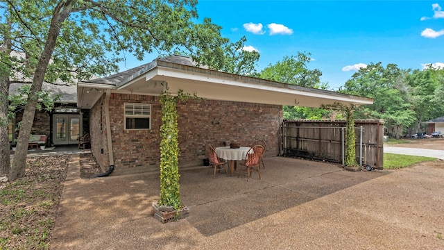 view of patio with french doors and fence