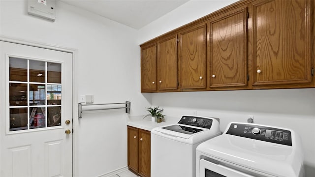 laundry room featuring washing machine and dryer and cabinet space