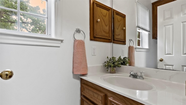 bathroom featuring a healthy amount of sunlight and vanity