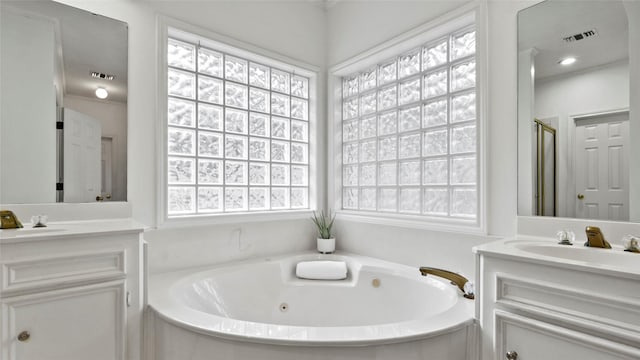 full bathroom with a whirlpool tub, a stall shower, visible vents, and vanity