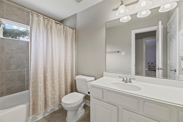 bathroom with toilet, tile patterned floors, shower / tub combo, and vanity
