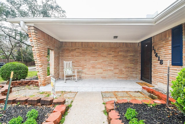 property entrance with brick siding