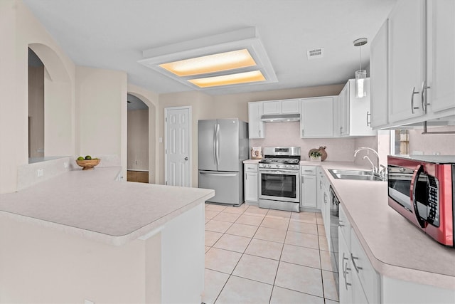 1635 Ashton Village Dr, Spring, TX 77386 - kitchen featuring a sink, light countertops, stainless steel appliances, under cabinet range hood, and visible vents