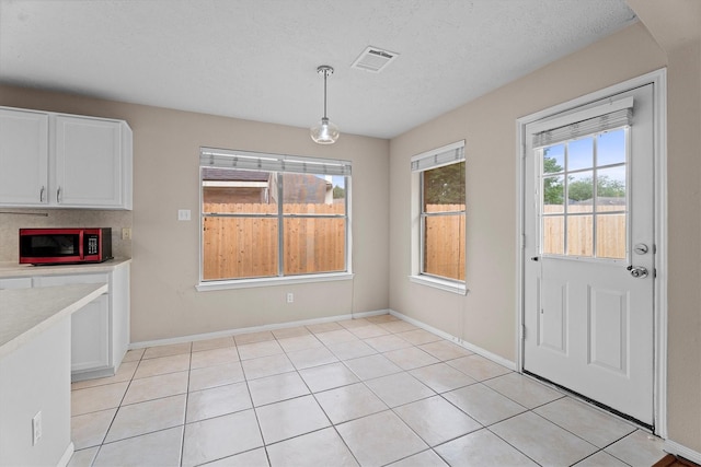 1635 Ashton Village Dr, Spring, TX 77386 - unfurnished dining area with visible vents, baseboards, and light tile patterned floors