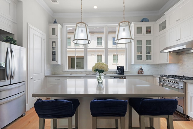6113 Nicholas Grove Pl, Houston, TX 77055 - kitchen featuring a center island, light countertops, under cabinet range hood, stainless steel appliances, and white cabinetry
