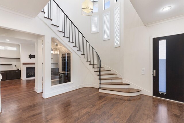 6011 Burgoyne Rd Unit A, Houston, TX 77057 - entryway with stairway, wood finished floors, baseboards, and a glass covered fireplace