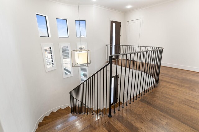 6011 Burgoyne Rd Unit A, Houston, TX 77057 - staircase featuring wood finished floors, baseboards, and ornamental molding