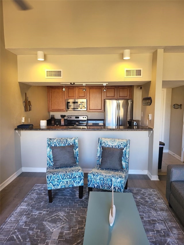 3922 Lakewood Dr, Montgomery, TX 77356 - living room featuring visible vents, baseboards, and dark wood-style floors