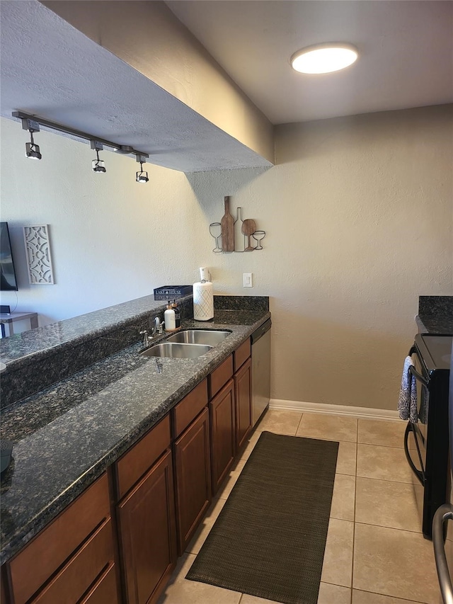 3922 Lakewood Dr, Montgomery, TX 77356 - kitchen featuring electric range, dishwasher, dark stone counters, a sink, and light tile patterned floors
