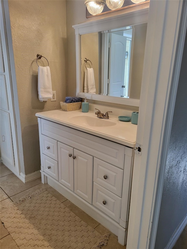 3922 Lakewood Dr, Montgomery, TX 77356 - bathroom with vanity, tile patterned flooring, and a textured wall