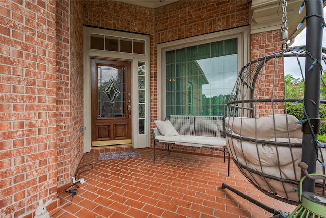 doorway to property featuring brick siding