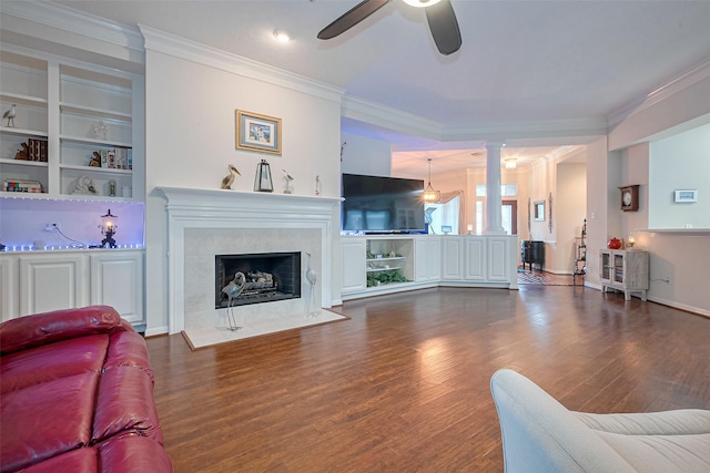 living area featuring a ceiling fan, wood finished floors, and ornamental molding