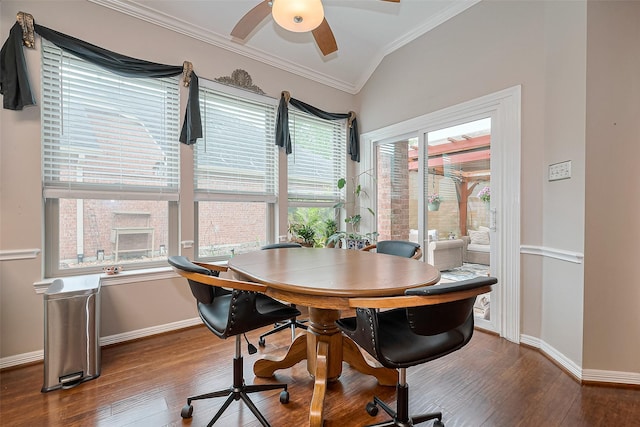 dining area featuring ceiling fan, crown molding, wood finished floors, baseboards, and lofted ceiling