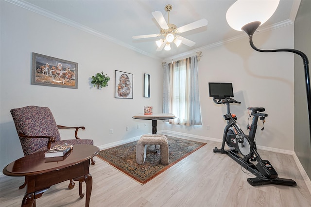 workout room with crown molding, a ceiling fan, baseboards, and wood finished floors