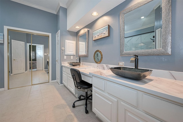 full bath featuring crown molding, a sink, tile patterned floors, and double vanity