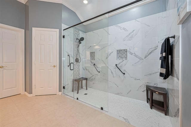 bathroom with ornamental molding and a marble finish shower