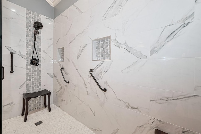 bathroom featuring a marble finish shower