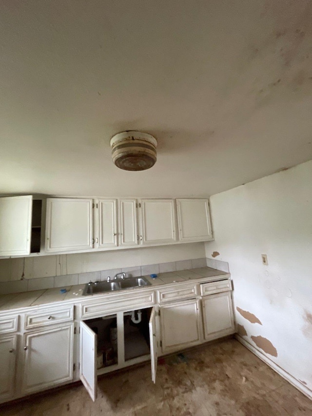 kitchen with white cabinets, open shelves, and a sink