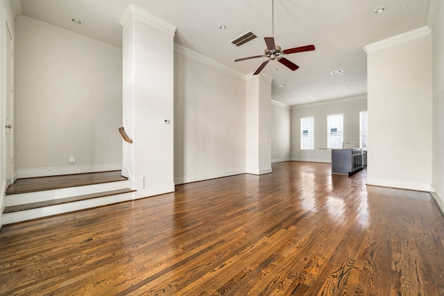 unfurnished living room with crown molding, baseboards, ceiling fan, and wood finished floors