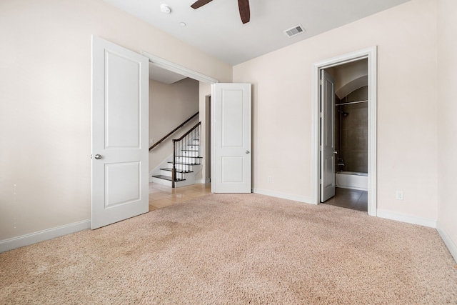 unfurnished bedroom with visible vents, a ceiling fan, carpet, and baseboards
