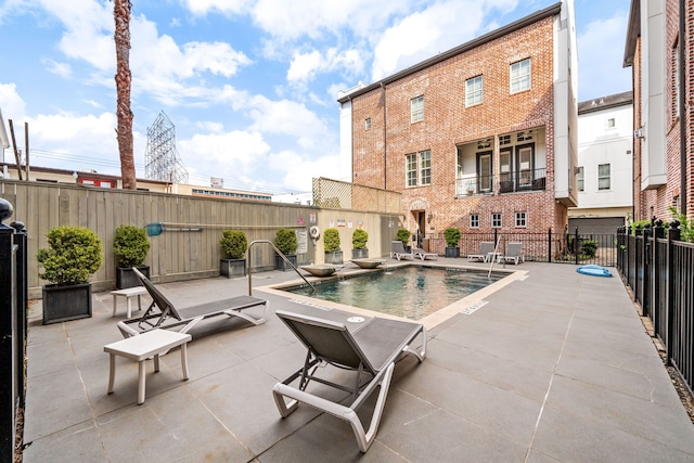 pool featuring a patio and fence