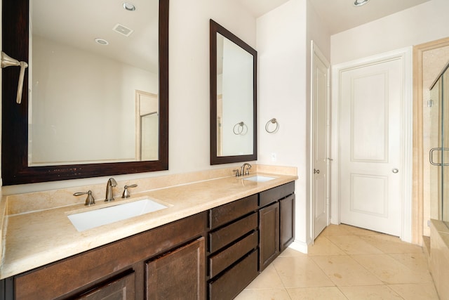 full bathroom with visible vents, a sink, a stall shower, and tile patterned floors