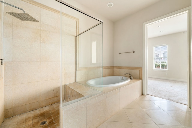full bath featuring tile patterned floors, a shower stall, and a garden tub