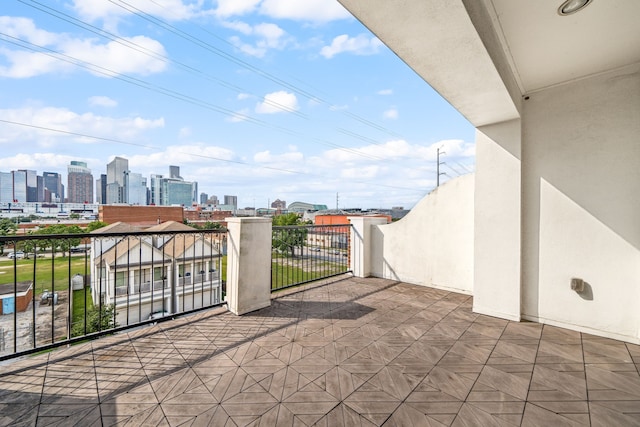 view of patio / terrace featuring a view of city and a balcony