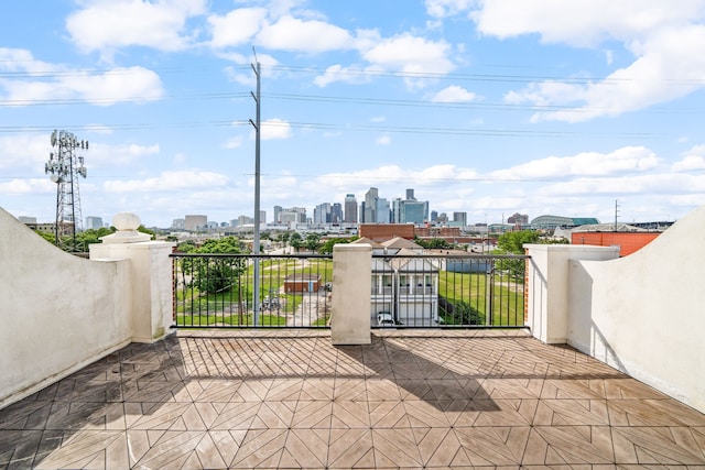 view of patio / terrace featuring a view of city and a balcony