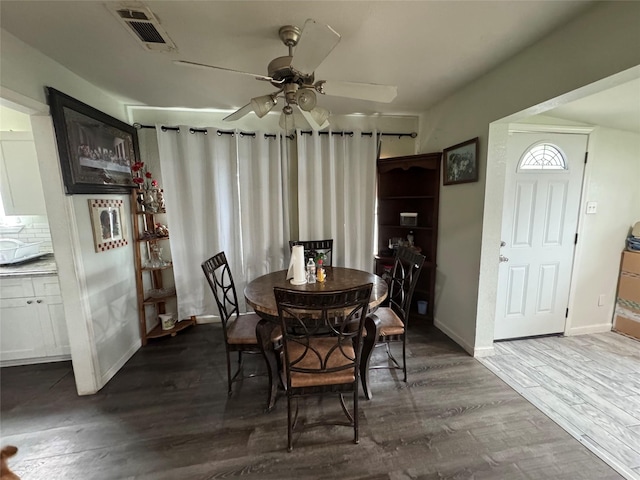 5526 Bunte St, Houston, TX 77026 - dining room featuring visible vents, dark wood-style flooring, ceiling fan, and baseboards