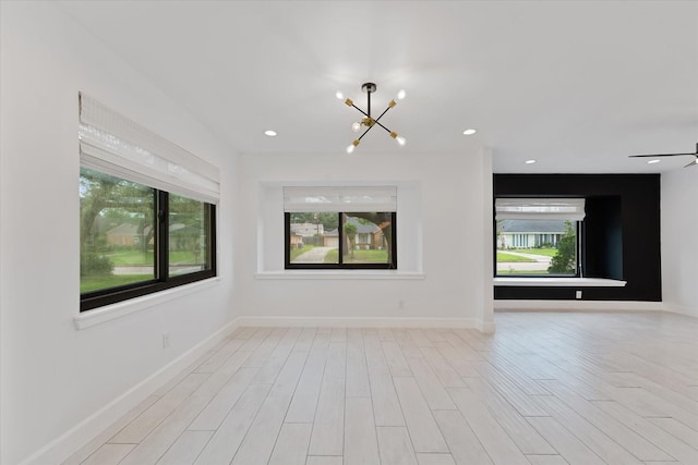 2611 Teague Rd, Houston, TX 77080 - spare room featuring an inviting chandelier, wood finished floors, baseboards, and recessed lighting