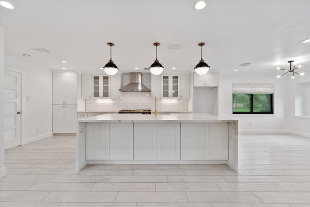 2611 Teague Rd, Houston, TX 77080 - kitchen featuring glass insert cabinets, a spacious island, white cabinetry, wall chimney exhaust hood, and backsplash