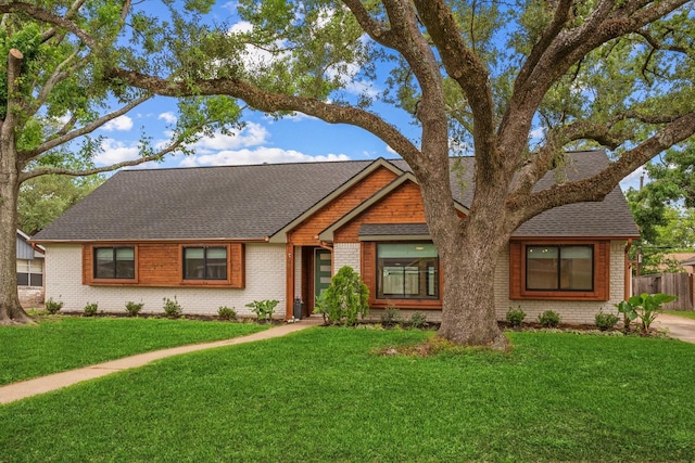 2611 Teague Rd, Houston, TX 77080 - ranch-style house featuring roof with shingles, brick siding, a front lawn, and fence