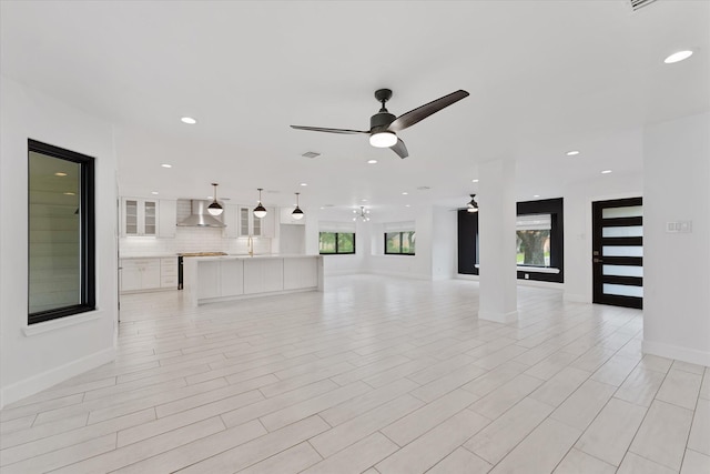 2611 Teague Rd, Houston, TX 77080 - unfurnished living room featuring ceiling fan, baseboards, visible vents, and recessed lighting