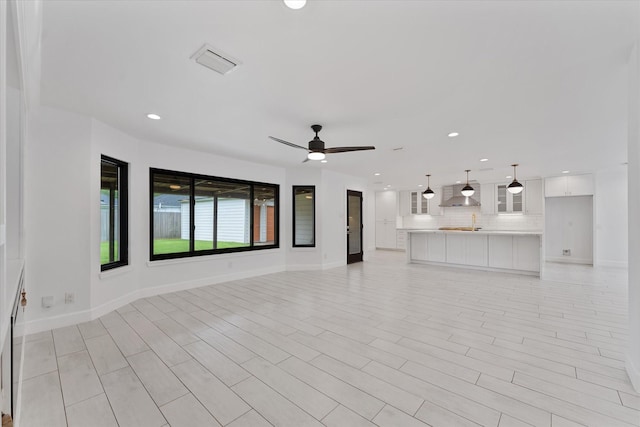 2611 Teague Rd, Houston, TX 77080 - unfurnished living room with visible vents, baseboards, a ceiling fan, and recessed lighting