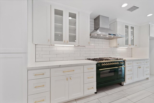 2611 Teague Rd, Houston, TX 77080 - kitchen featuring double oven range, white cabinets, visible vents, and wall chimney exhaust hood