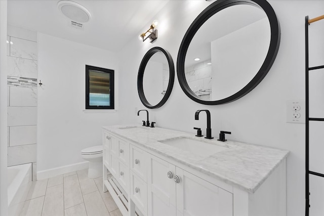 2611 Teague Rd, Houston, TX 77080 - full bathroom featuring toilet, baseboards, double vanity, and a sink